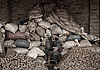 Potato Pile Photo: At the daily market in Lijiang, a potato farmer proudly displays his merchandise.