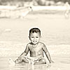 Sandy Hair Photo: A local Thai boy plays in the soggy sand after the tide has receded.