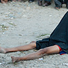 Master Showman Photo: A "magic" show performed on a field for a captive audience.  From what I can gather (my Nepali is a bit rusty), the man under cloth appears to be dead.  The magician revives the deceased by removing various bloody organs... when, and only when, donations have been collected from the crowd.