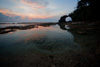 Far (Natural Bridge III) Photo: Natural Bridge and sky reflected in a shallow pool of sea water.