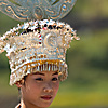 Miao Beauty (Miao I) Photo: A Miao ethnic minority woman, dressed in traditional festival ornamentation, waits for the beginning of a celebration.