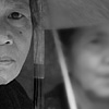 Sun Protection Photo: Three women await funeral ceremonies in Tana Toraja, an area where funeral services are lavishly and ritualistically performed.  It's not uncommon for a wealthy family to sacrifice several dozen pigs and several dozen water buffalo over the course of a few days.