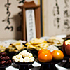 Ancestor Appreciation Photo: The eldest living male in the family, in this case my eldest uncle, holds the responsibility to prepare offerings for Chuseok (추석) celebration.  Here, he ritualistically pours and twice circles soju, a Korean rice wine, around incense to offer thanks to his father (my grandfather) as well as previous ancestors.  Note the traditional Korean garb worn for the occasion called a hanbok (한복).