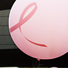 Awareness, Education, Empowerment Photo: Youngsters hangin' by the faux river surrounded by pink balloons, umbrellas and ribbons.