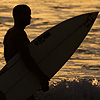 Frothy Walk Photo: A pair of surfers head home after an evening of catching waves at touristy Kuta beach in Bali.