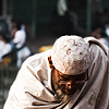 Down On His Luck Photo: A tired Muslim beggar sifts through his equally tired and broken bag at the south entrance of Jama Masjid.