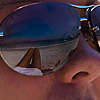 Beauty & the Beach Photo: Legs and sea reflected in a British girl's sunglasses.