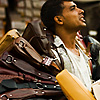 Leather Loop Photo: A Nepali salesman is encircled by a ring of women's handbags.