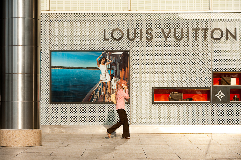 An ethnic Malay woman walks in front of a Louis Vuitton store. - Kuala Lumpur, Malaysia - Daily Travel Photos