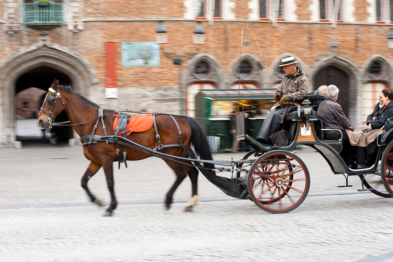 A tourist horse and buggy glide past the belfry on Grote Markt. - Brugge, Belgium - Daily Travel Photos