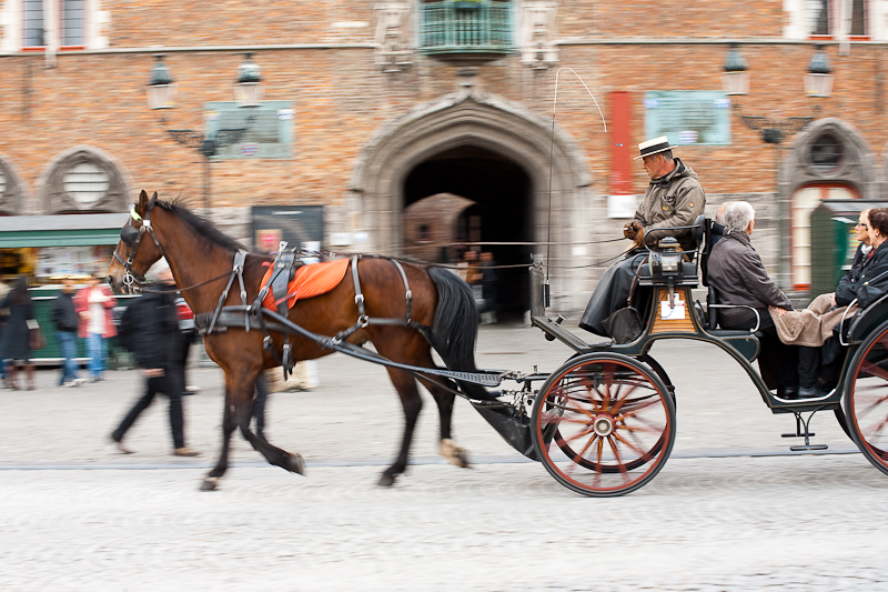 A tourist horse and buggy glide past the belfry on Grote Markt. - Brugge, Belgium - Daily Travel Photos