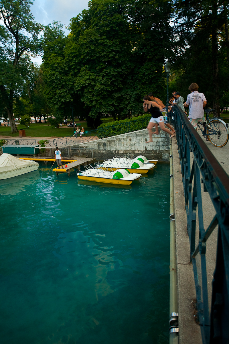 French children jump from a bridge into beautiful lake Annecy - Annecy, France - Daily Travel Photos