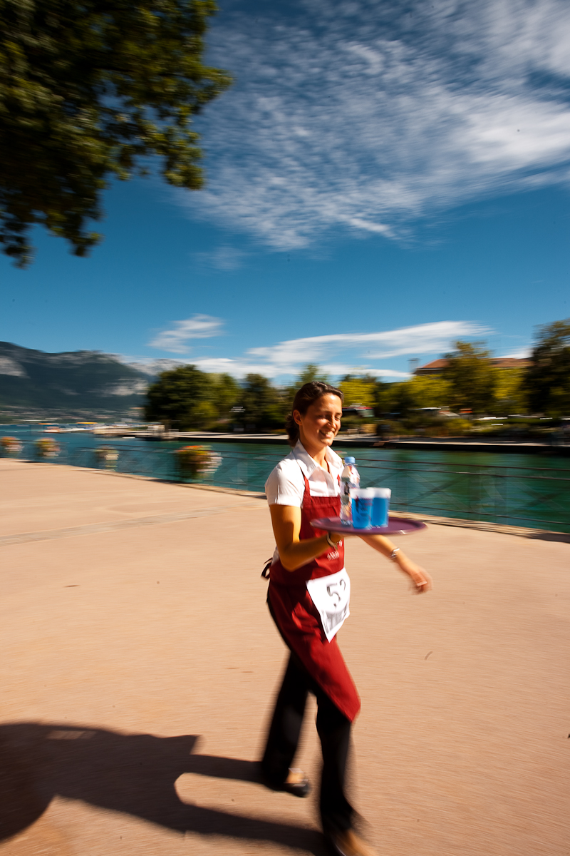 Cute waitress hamming for the camera nearly drops her drinks at the Waiter's Run - Annecy, Haute-Savoie, France - Daily Travel Photos