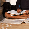 Well Grounded Photo: A boy and his goat put the finishing touches on homework before the start of school.