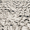 Sand Dunes Photo: A longtail boat waits grounded on a richly textured sea floor.
