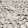 Sand Dunes Photo: A longtail boat waits grounded on a richly textured sea floor.