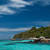 Stoned Photo: A snorkeler maneuvers around a small set of rocky outcroppings.