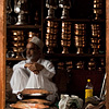 Striking Shopkeeps Photo: A silver and copper goods salesman sits idle on a slow business day.