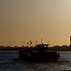 Low-Grade Refinement Photo: A barge slowly cruises past an oil refinery on the Scheldt river.