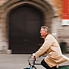 photo: Saddlebags - Panned photo of a bicyclist in front of Grote Markt's belfry.