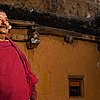 Mountain Monastery Photo: A monk inside the courtyard of the small monastery built into a cliff opposite the Dhankar monstery.