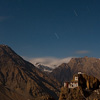 Midnight Monastery Photo: Buddhist monastery built into the side of a mountain and cliffs.