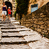 Bouldery Boulevard Photo: Tourists climb down a hilly stone path of Gordes, a picturesque Provencal village.