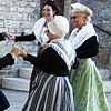 Period Performance Photo: Traditionally dressed women in period costume perform a dance at the church square.