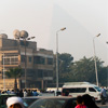 Round-Trip Ruins Photo: The Great Pyramid of Cheops is faintly visible through a thick layer of haze and smog.