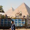 Historical 'Hood Photo: An Egyptian man walks on a road adjacent to the Great Pyramids of Giza.