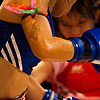 Female Muay Thai Kickboxing Photo: A female muay thai kickboxer receives a kick, sending sweat flying.