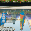 Stilt Clowns Reflection Photo: Stilt walking clowns reflected in a fountain at a mall event.