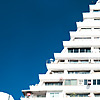 Individual Living Units Photo: A downtown triangular apartment building is decked out with personal air conditioners and satellite dishes.