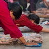 Tibetan Pilgrim Prostration Photo: A Tibetan woman in mid-prostration at the Jokhang temple in Lhasa (ARCHIVED PHOTO on the weekends - originally photographed 2007/10/17).