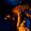 Thai Dance Puppet Master Photo: A male Thai traditional dancer slings an inanimate female dancer over his shoulder.