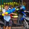 Songkran Water Fight Photo: An open-bed truck does a drive-by shooting during the first day of Songkran festival which marks the beginning of the Thai new year.