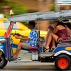 Songkran Tuk-Tuk Attacks Photo: Thai tuk-tuk passengers cower in terror from a barrage of water-gun attacks during Songkran.