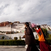 Potala Palace Plebeians Photo: Two Tibetan women in traditional dress cross the front of the Potala Palace in Lhasa (ARCHIVED PHOTO on the weekends - originally photographed 2007/10/17).