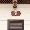 Skull Studded Photo: A mixed set of skulls adorn the side of a building in a residential neighborhood in Bangkok.