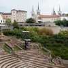 Dramatic Venue Photo: The preserved Roman theater and Basilica of Notre Dame de Fourviere in the distance in Lyon.