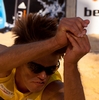 Digging Diver Photo: A men's beach volleyball player sacrifices his body in a dive, positioning himself nearly horizontal to the sand.