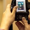 Mild Mannered Mob Photo: Camera held high to overcome the crowds in the room containing the Mona Lisa at the Louvre museum.