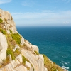 Typical Topography Photo: Tourists walk along a high cliff path above the ocean in Dongyin, Matsu Islands, Taiwan