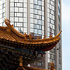 Construction Contrast Photo: A modern skyscraper and traditional Chinese gateway in downtown Kunming, China (ARCHIVED PHOTO on the weekends - originally photographed 2007/06/09).